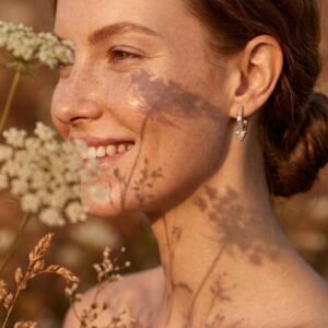 Woman wearing Halo Prism Hoops in warm natural light